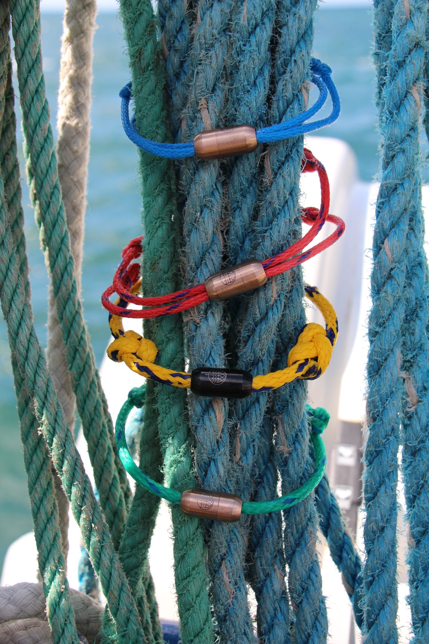 stack of Bracenets on arm in ocean